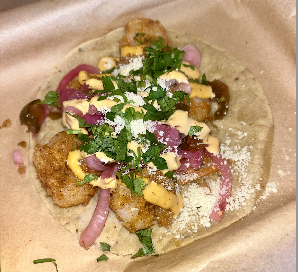 Torchy’s Tacos signature Baja shrimp taco sprinkled with cilantro and cotija cheese, as photographed Oct. 4, 2024. (Hustler Staff/Lucia Gutierrez)